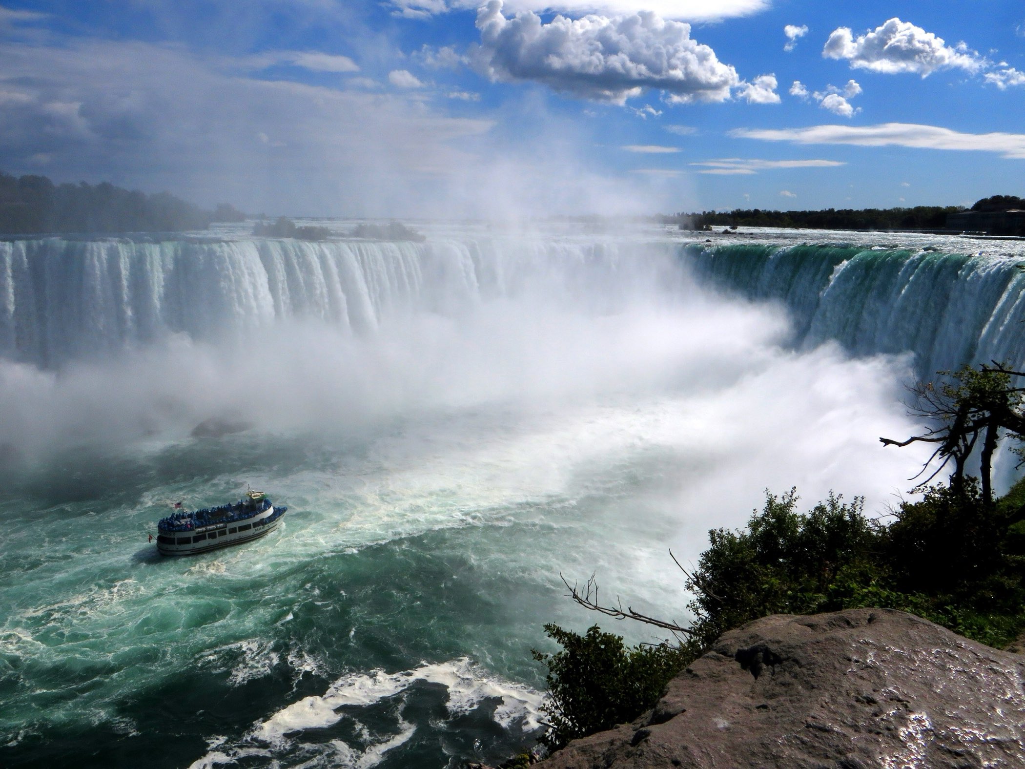 A Niagara tour boat at the misty base of Horseshoe Falls